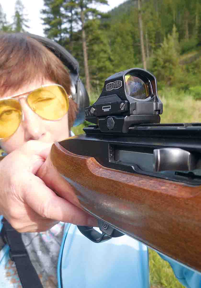 Reflex sights have an unlimited amount of eye relief that makes them quick to aim. Gail Haviland is shooting targets with a Meopta MeoRed sight on a Ruger 10/22.